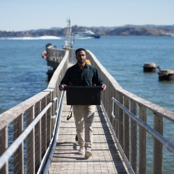 Graduate student collects samples from the finger pier